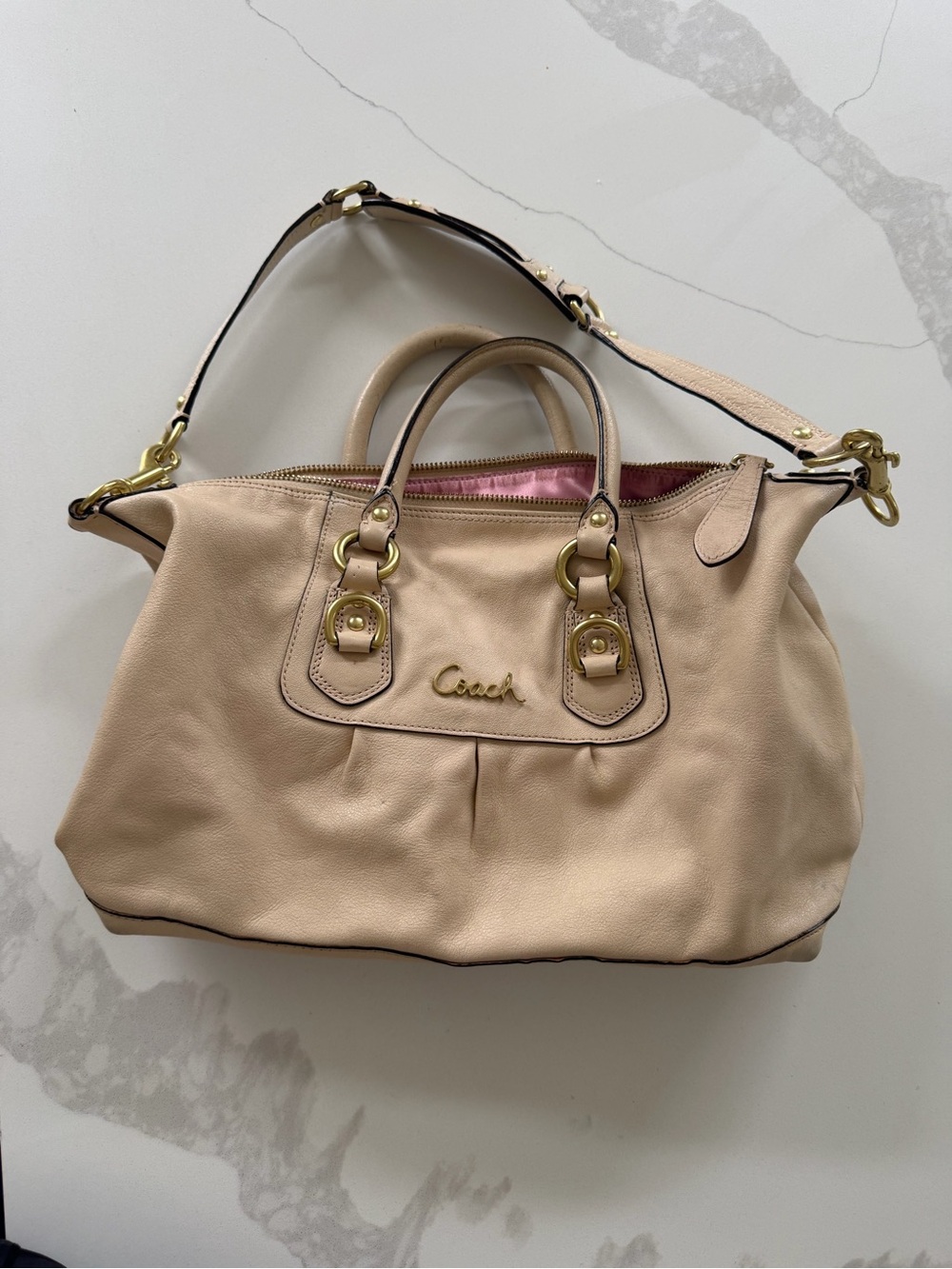 cream-colored Coach Ashley Leather Script Satchel
